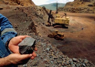 Worker Holding Iron Ore Rock
